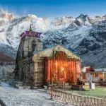 Kedarnath Temple decorated with lights, surrounded by snow-capped Himalayan peaks—a highlight of our Chardham yatra package.